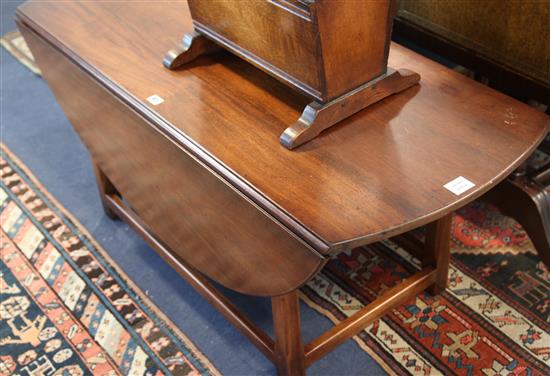 A George III style mahogany circular drop leaf low table, W.125cm